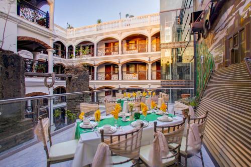 a balcony with a table and chairs and a building at Hotel Luna in Vigan