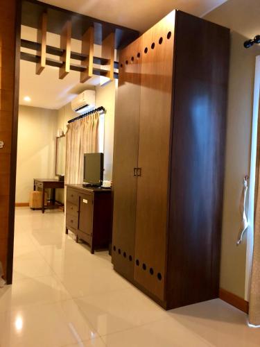 a room with a bathroom with a locker and a television at Hua Hin White Sand in Hua Hin