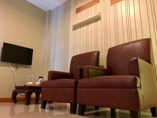 a living room with two chairs and a table at Hua Hin White Sand in Hua Hin