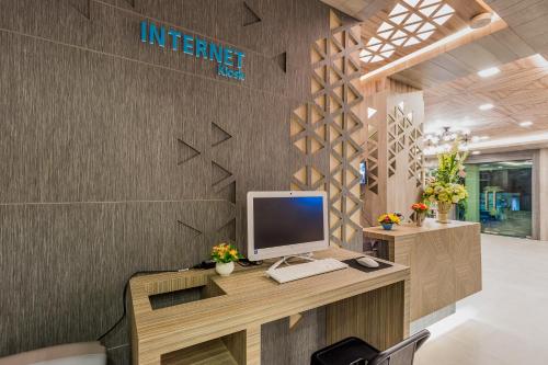 an office with a desk with a computer on it at Evergreen Suite Hotel in Surat Thani