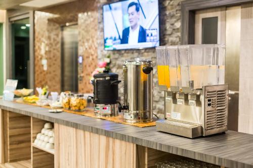 a counter with a blender on top of it at Evergreen Suite Hotel in Surat Thani