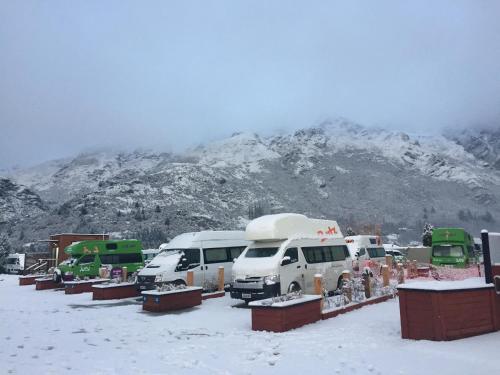 a group of trucks parked in a snow covered field at Queenstown Top 10 Holiday Park in Queenstown