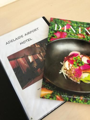 two books sitting on top of a table at Adelaide Airport Motel in Adelaide