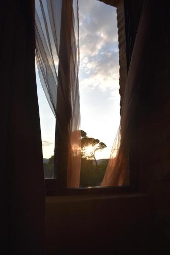a window with a view of the sunset at Mas d'Asvin & Spa in Saint-Christol-lès-Alès