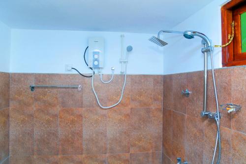 a shower in a bathroom with a glass door at Sigiri Mango Garden Eco Resort in Sigiriya