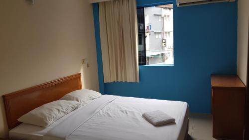 Una cama o camas en una habitación de Prime Hotel