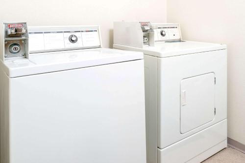 two washing machines and a washer and dryer in a room at Red Lion Inn & Suites Gretna - Omaha SW in Gretna