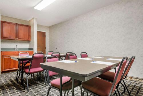 a conference room with a table and pink chairs at Days Inn by Wyndham Norton in Norton