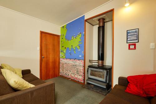 
a living room filled with furniture and a fire place at Dolphin Lodge in Kaikoura
