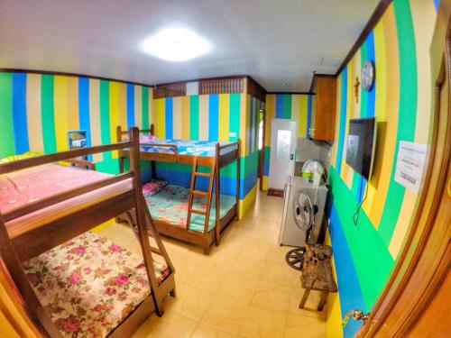 a room with two bunk beds and a hallway at Tagaytay Bloom Breeze Cruz Apartelle in Tagaytay