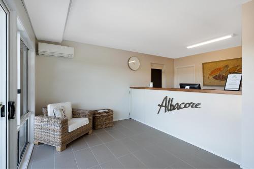 a lobby of an office with a counter and chairs at Albacore Apartments in Merimbula