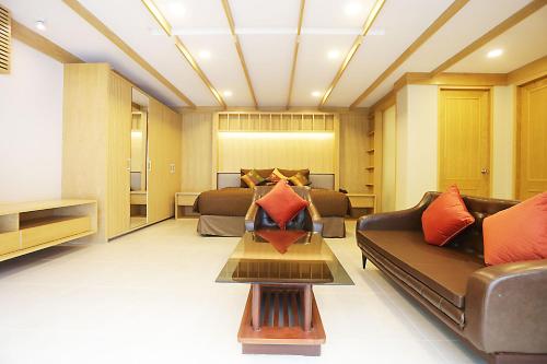 a living room with a couch and a bed at Hua Hin White Sand in Hua Hin