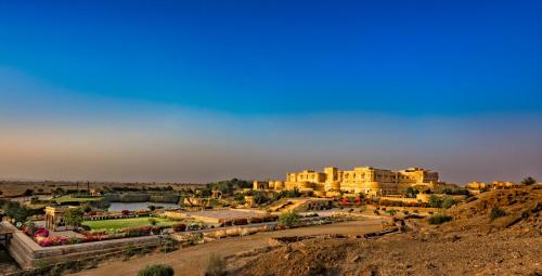 a view of a city with buildings and a river at Suryagarh Jaisalmer in Jaisalmer