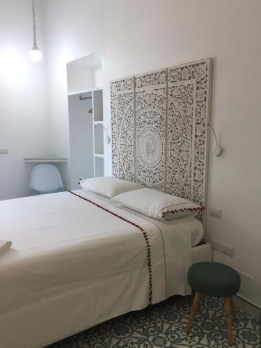 a bedroom with a large white bed and a chair at Vesuvio View in Vico Equense