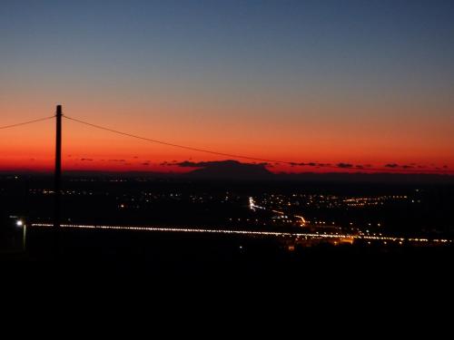 a sunset over a city with a telephone pole at Nestos, Meer und Berge - Griechenland mal anders in Zarkadhiá