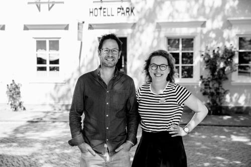 a man and a woman standing in front of a building at Hotell Park in Västervik