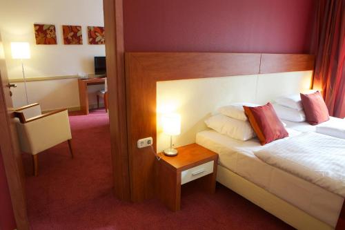 a hotel room with a bed and a table with a lamp at Hotel City Inn in Budapest