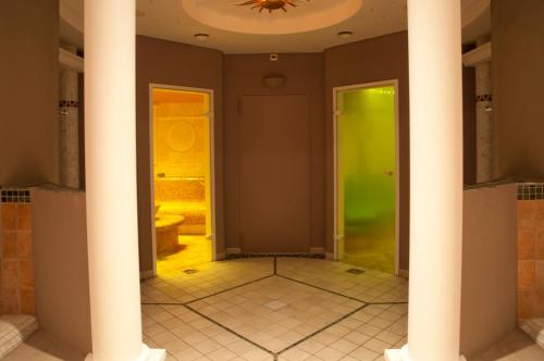 a room with two columns and a green door at Hotel Rosatsch in Pontresina