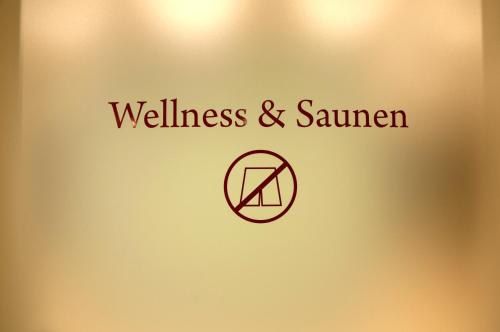 a door with a sign that reads wellness and summer at Hotel Rosatsch in Pontresina
