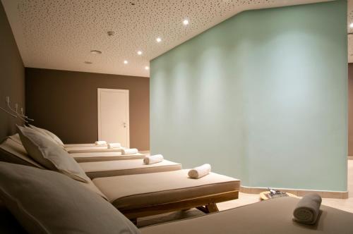 a room with a bunch of beds in it at Hotel Rosatsch in Pontresina