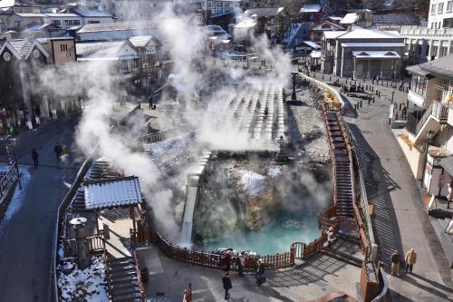 an amusement park with a steam train and a pool at Daitokan in Kusatsu