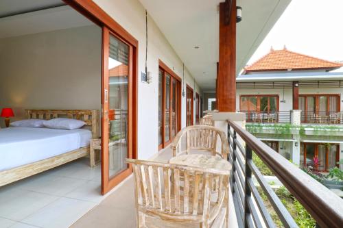 a balcony with a bedroom and a bed on a balcony at Avisara Villa & Suite in Nusa Dua