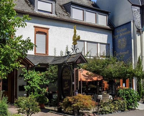 a building with a restaurant in front of it at Weinhaus Burg-Schneider in Reil