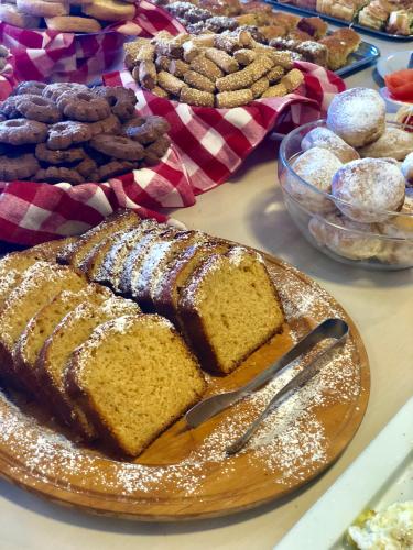a table topped with a plate of bread and pastries at Fedriades Delphi Hotel in Delfoi