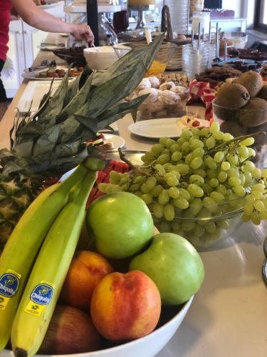 a bowl of fruit on a counter with bananas and apples at Fedriades Delphi Hotel in Delfoi