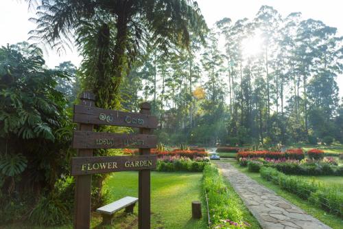 a sign in a park with a flower garden at Heaven Seven Nuwara Eliya in Nuwara Eliya