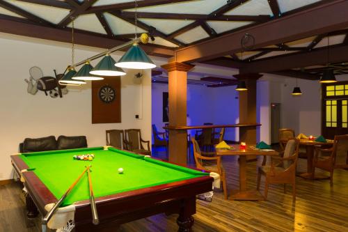 a living room with a pool table and tables at Heaven Seven Nuwara Eliya in Nuwara Eliya