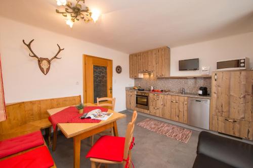 a kitchen with a table and a dining room at Apartmenthaus Gotthardt in Kaprun