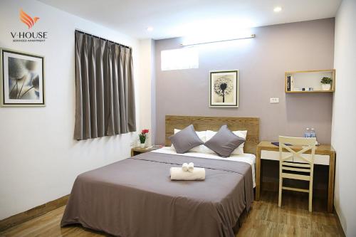Postel nebo postele na pokoji v ubytování V House 5 Serviced Apartment