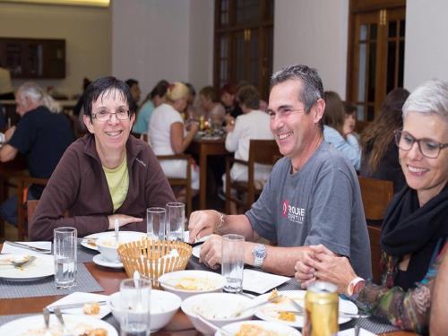 a group of people sitting at a table eating food at Heaven Seven Nuwara Eliya in Nuwara Eliya