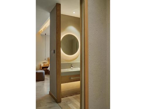 a bathroom with a sink and a mirror at EBO Hotel Hangzhou Wulin - 5 mins drive to the West Lake in Hangzhou