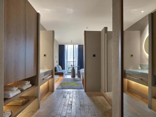 a hallway with a bathroom with a sink at EBO Hotel Hangzhou Wulin - 5 mins drive to the West Lake in Hangzhou