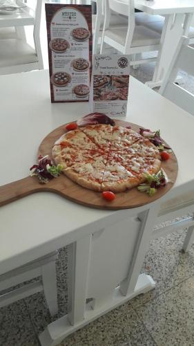 a pizza sitting on top of a table at Polyxeni Hotel Apartments in Limassol