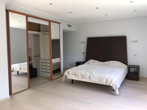 a bedroom with a bed and a large mirror at Villa with Heated Pool and Jacuzzi close to Puerto Banus and Beach in Estepona