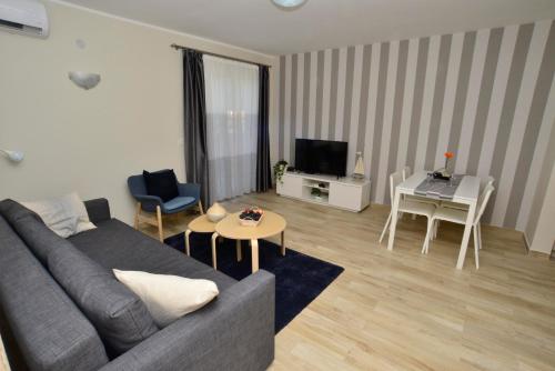 a living room with a couch and a table at Apartman Bradasevic Tivat in Tivat