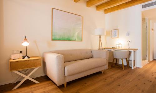 a living room with a couch and a table at Forum Boutique Hotel & Spa - Adults Only in Alcudia