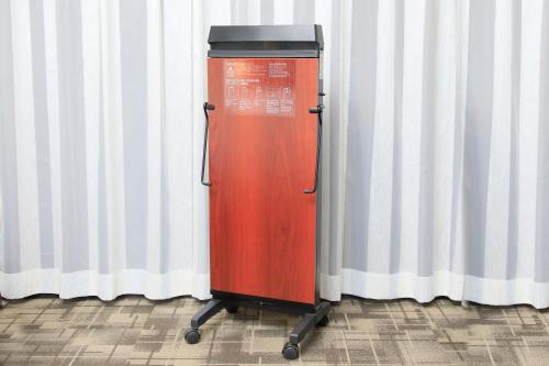 a red object is sitting in front of a curtain at Richmond Hotel Higashi Osaka in Osaka