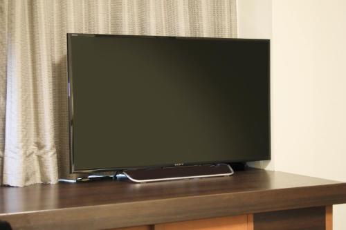 a flat screen tv sitting on top of a table at Richmond Hotel Higashi Osaka in Osaka
