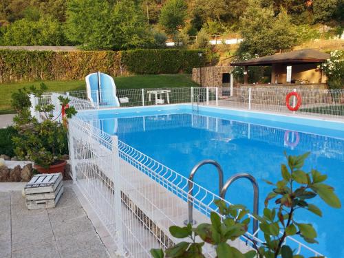 a swimming pool with a white fence around it at Hospedium Hotel Val de Pinares in Bogarra