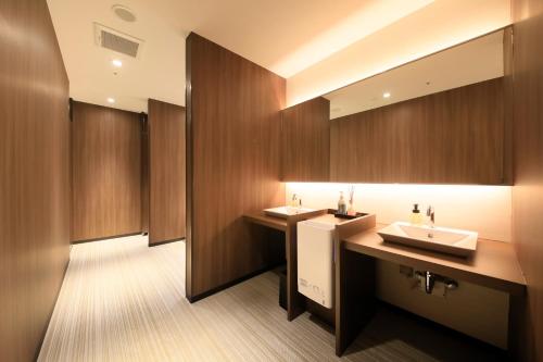 a bathroom with two sinks and a mirror at Richmond Hotel Higashi Osaka in Osaka