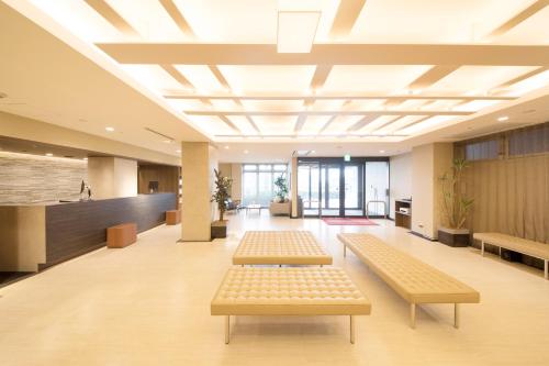 a hospital waiting room with benches in the middle at Richmond Hotel Higashi Osaka in Osaka