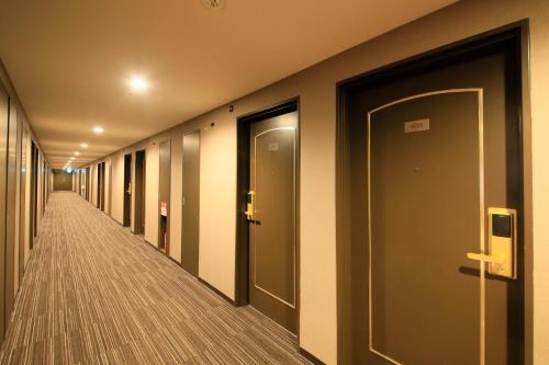 a hallway of an office building with doors and a walkway at Richmond Hotel Higashi Osaka in Osaka
