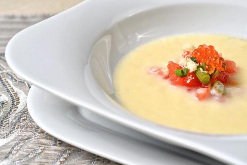 a white bowl of soup with tomatoes in it at Lubhotel in Lublin