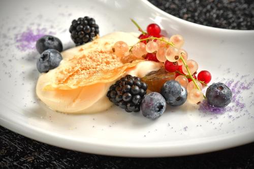 a dessert with berries on a white plate at Lubhotel in Lublin