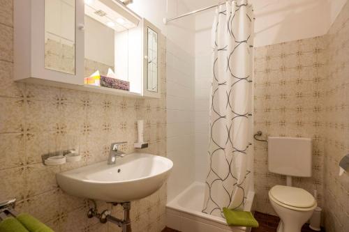 a bathroom with a sink and a toilet at Gästehaus Greger in Sankt Johann in Tirol