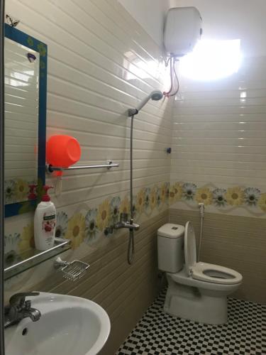 a bathroom with a toilet and a sink at Cat Ba Mystery Homestay in Cat Ba